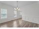 Bright dining room with elegant wainscoting, chandelier, and wood-look floors for modern living at 185 Keller Dr, Clayton, NC 27520