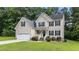 Attractive two-story home boasting mature landscaping, a two-car garage, and a welcoming facade at 185 Keller Dr, Clayton, NC 27520