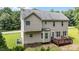 Elevated rear view of home, deck, and yard with mature trees at 185 Keller Dr, Clayton, NC 27520