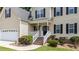 Welcoming front entrance with brick stairs, white railing, and a well-manicured lawn at 185 Keller Dr, Clayton, NC 27520