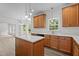 Modern kitchen features an island, light countertops, wood cabinets, and stainless steel appliances at 185 Keller Dr, Clayton, NC 27520