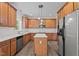 Stylish kitchen with island, stainless steel appliances, ample wooden cabinetry, and sleek countertops at 185 Keller Dr, Clayton, NC 27520