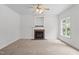 Spacious living room featuring neutral carpet, a fireplace, and a ceiling fan at 185 Keller Dr, Clayton, NC 27520