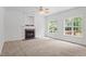 Bright living room offering fireplace, neutral carpet, ceiling fan, and lots of natural light at 185 Keller Dr, Clayton, NC 27520