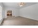 Spacious living room with neutral carpet, ceiling fan, and view to kitchen at 185 Keller Dr, Clayton, NC 27520