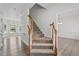Elegant staircase with wooden handrail and plush carpet runner in bright, freshly painted home at 185 Keller Dr, Clayton, NC 27520