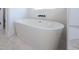Modern bathroom features a sleek, freestanding white bathtub with stylish black faucet at 188 Banner Elk Rd, Benson, NC 27504