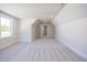 Spacious bedroom featuring plush carpeting, natural light from the windows, and a neutral color palette at 188 Banner Elk Rd, Benson, NC 27504