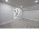Bedroom with neutral carpet, a vaulted ceiling, and an open doorway to another room at 188 Banner Elk Rd, Benson, NC 27504