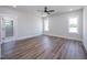 Spacious bedroom with wood floors and ample natural light from windows at 188 Banner Elk Rd, Benson, NC 27504
