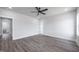 Spacious bedroom featuring a ceiling fan and wood floors at 188 Banner Elk Rd, Benson, NC 27504