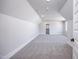 Bright and airy bedroom features neutral carpet, trim, and paint with a walk-in closet and dormer windows at 188 Banner Elk Rd, Benson, NC 27504