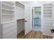 Spacious walk-in closet with custom shelving and an attached laundry area with a sink at 188 Banner Elk Rd, Benson, NC 27504