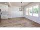 Bright dining room featuring hardwood floors, modern lighting, and large windows providing ample natural light at 188 Banner Elk Rd, Benson, NC 27504