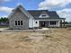 Charming new construction home with stone accents, a covered porch and manicured yard at 188 Banner Elk Rd, Benson, NC 27504