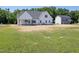 White farmhouse exterior with covered back porch and spacious yard at 188 Banner Elk Rd, Benson, NC 27504