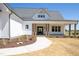 Beautiful home showcasing fresh landscaping, covered porch and custom front door at 188 Banner Elk Rd, Benson, NC 27504