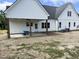 New construction home features covered patio with ceiling fan and backyard at 188 Banner Elk Rd, Benson, NC 27504