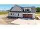 Aerial view of home featuring a stained wood garage door and concrete driveway at 188 Banner Elk Rd, Benson, NC 27504