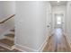 Hallway featuring stairs and wood floors at 188 Banner Elk Rd, Benson, NC 27504