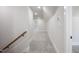 Upstairs hallway with neutral carpet and white walls, leading to additional rooms at 188 Banner Elk Rd, Benson, NC 27504