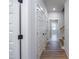Bright hallway featuring wood floors, white doors, trim, and access to other rooms at 188 Banner Elk Rd, Benson, NC 27504