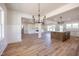 Open-concept living area featuring hardwood floors, modern lighting and fireplace at 188 Banner Elk Rd, Benson, NC 27504