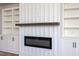 Modern electric fireplace with a wooden mantel, flanked by built-in shelves at 188 Banner Elk Rd, Benson, NC 27504