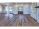 Spacious living room featuring hardwood floors, columns, and a stylish front door at 188 Banner Elk Rd, Benson, NC 27504