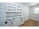 Office featuring built-in white shelves, cabinets, granite countertop and hardwood floors at 188 Banner Elk Rd, Benson, NC 27504