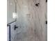 Modern shower with herringbone tile flooring, accent wall, and glass door with matte black trim at 188 Banner Elk Rd, Benson, NC 27504