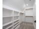 Spacious walk-in closet with built-in shelves and hanging rods, maximizing storage and organization at 188 Banner Elk Rd, Benson, NC 27504