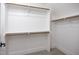 Spacious walk-in closet with carpet flooring, white walls, and wooden closet rods for optimal storage at 188 Banner Elk Rd, Benson, NC 27504