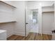 Walk-in closet with wood floors and access to the main bath at 188 Banner Elk Rd, Benson, NC 27504
