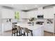 Bright, modern kitchen features a large island, white cabinets, and stainless steel appliances at 198 Blue Butterfly Dr, Angier, NC 27501