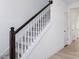 Stylish staircase with carpeted steps, white risers and dark wood handrail to the second floor at 198 Blue Butterfly Dr, Angier, NC 27501
