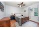 Cozy bedroom with hardwood floors, ceiling fan, and natural light from the window at 200 W Woodcroft Pkwy # 57B, Durham, NC 27713