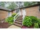 Attractive brick home boasting a welcoming entrance, vibrant floral arrangements, and established landscaping at 200 W Woodcroft Pkwy # 57B, Durham, NC 27713