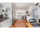 Well-lit kitchen with white cabinetry, stainless steel appliances, and a view to the outdoor patio at 200 W Woodcroft Pkwy # 57B, Durham, NC 27713
