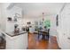 Bright kitchen featuring white cabinets, stainless steel appliances, eat-in dining area, and wood flooring at 200 W Woodcroft Pkwy # 57B, Durham, NC 27713