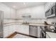 Clean kitchen featuring stainless steel appliances, ample white cabinetry, and hardwood flooring at 200 W Woodcroft Pkwy # 57B, Durham, NC 27713