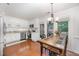 Bright kitchen features white cabinetry, stainless steel appliances, and an adjacent dining area with outdoor access at 200 W Woodcroft Pkwy # 57B, Durham, NC 27713