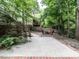 Well maintained backyard featuring a fire pit and manicured trees and landscaping at 203 Chilcott Ln, Apex, NC 27502