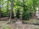 Wood footbridge leads into a serene and shaded backyard at 203 Chilcott Ln, Apex, NC 27502