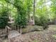 Secluded backyard with footbridge leading to a peaceful creek and wooded area at 203 Chilcott Ln, Apex, NC 27502
