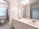 Clean bathroom with marble floors, dual sinks, and vanity with large mirror at 203 Chilcott Ln, Apex, NC 27502