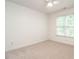 Comfortable bedroom featuring two windows, neutral carpeting, and a ceiling fan at 203 Chilcott Ln, Apex, NC 27502