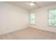 Bedroom featuring neutral carpeting and two windows, providing ample natural light at 203 Chilcott Ln, Apex, NC 27502