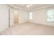 Spacious bedroom with neutral carpet, a ceiling fan, and natural light streaming through the windows at 203 Chilcott Ln, Apex, NC 27502