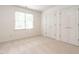 Bedroom features neutral carpeting, natural light, and double door closets at 203 Chilcott Ln, Apex, NC 27502